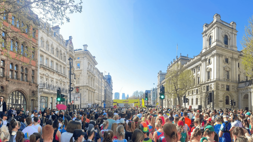 Blue sky over a large group of people ready to run the London Landmarks Half Marathon