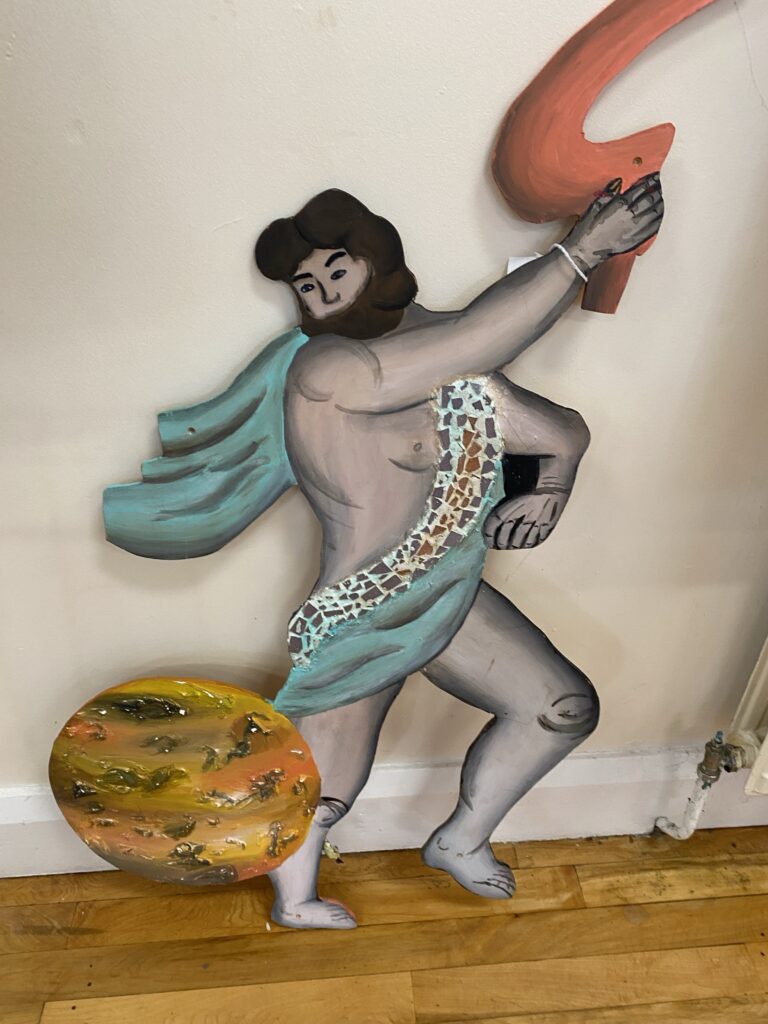 A painted mystical creature on a wooden board