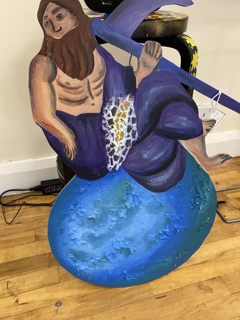 A painted mystical creature on a wooden board